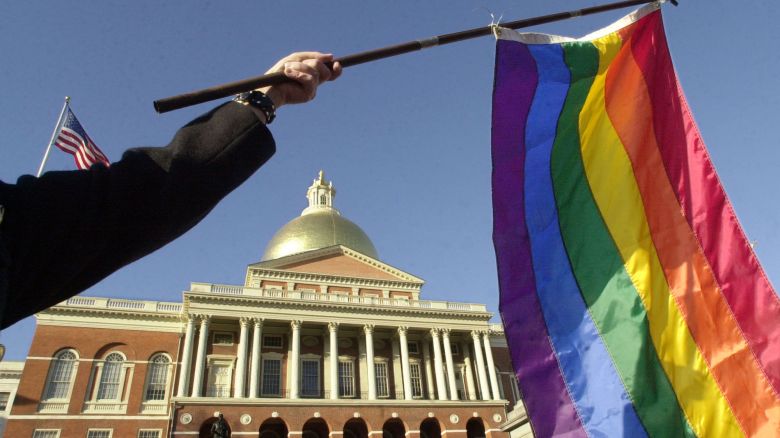 BOSTON, MA - FEBRUARY 12:  A supporter of gay marriage waves a rainbow flag outside the Massachusetts State House, where the Legislature was in its second day of debate over a possible constitutional amendment banning same-sex marriage February 12, 2004 in Boston, Massachusetts.  The proposed amendment, supported by Governor Mitt Romney, was drafted in response to a state Supreme Judicial Court ruling declaring that the right to same-sex marriage was protected by the state's constitution.    (Photo by Michael Springer/Getty Images)