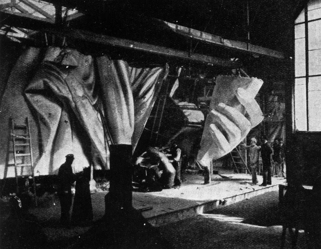 A photo showing the left hand of the Statue of Liberty under construction.