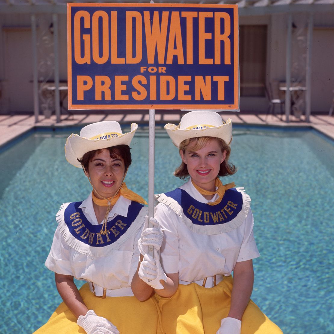 Two "Goldwater girls" campaigning for Barry Goldwater, the Republicans' 1968 presidential candidate, with blue placards.