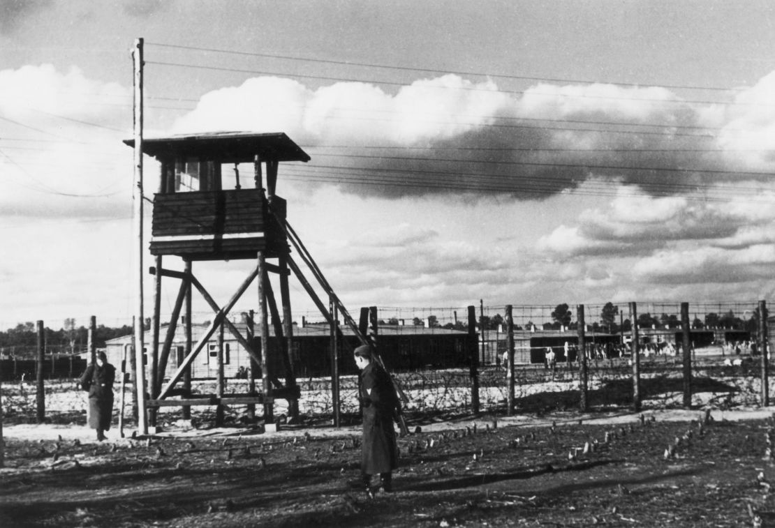 The camp was encircled by barbed wire fences and a series of watchtowers manned by armed guards.