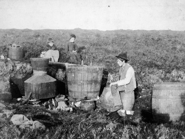 <strong>Irish moonshine:</strong> Poitín (pronounced "potch-een") is one of the oldest spirits in the world but only became legal in its native Ireland in 1997. Pictured: Children sitting by illegal poitín stills circa 1885.