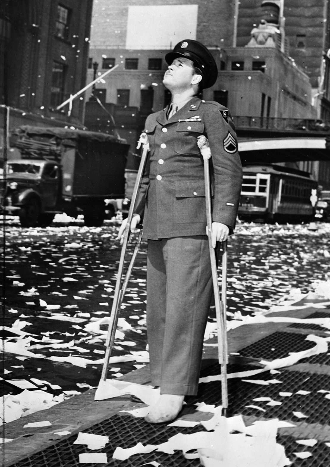 A wounded American serviceman attends a ticker tape parade in New York City on May 7, 1945, following press reports of the unconditional surrender of Germany.