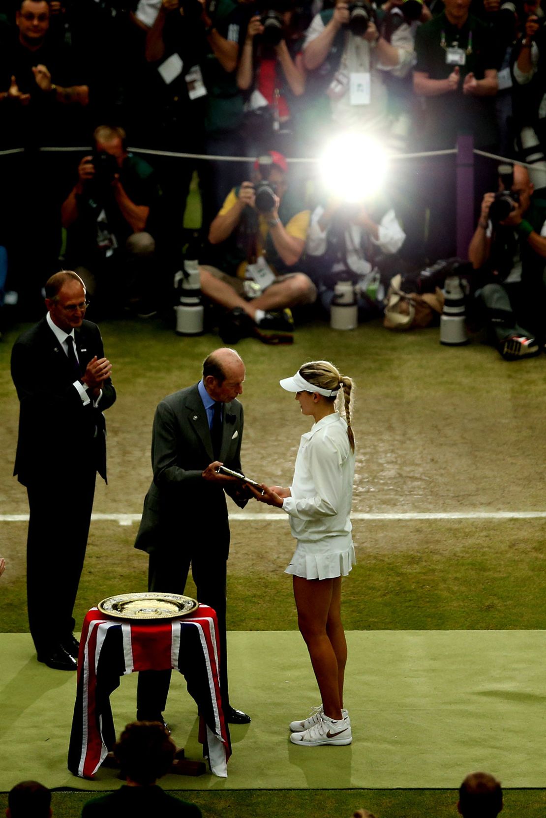 Bouchard receives the Wimbledon runners-up trophy after losing the 2014 final against Petra Kvitová.