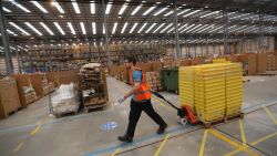 PETERBOROUGH, ENGLAND - NOVEMBER 28:  Employees select and dispatch items in the huge Amazon 'fulfilment centre' warehouse on November 28, 2013 in Peterborough, England. The online retailer is preparing for 'Cyber Monday', as it predicts the busiest day for online shopping in the UK will fall on Monday December 2nd this year. On Cyber Monday in 2012 amazon.co.uk recorded over 3.5 million individual items ordered, which equates to 41 items purchased per second. The Peterborough fulfilment centre is 500,000 sq ft, equivalent to approximately seven football pitches in floor area. Amazon are due to employ more than 1,000 seasonal staff to cope with increased demand in the run up to Christmas.  (Photo by Oli Scarff/Getty Images)