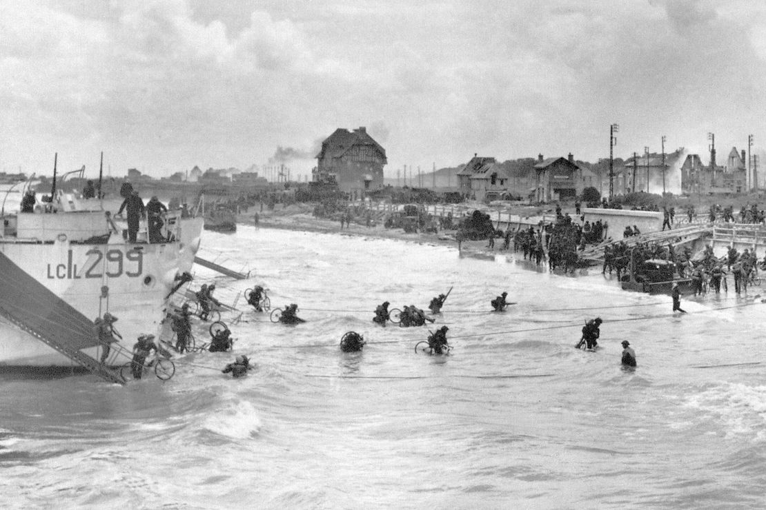 Canadian soldiers from 9th Brigade are seen landing at Juno Beach on D-Day. The house in the center managed to survive the battle.