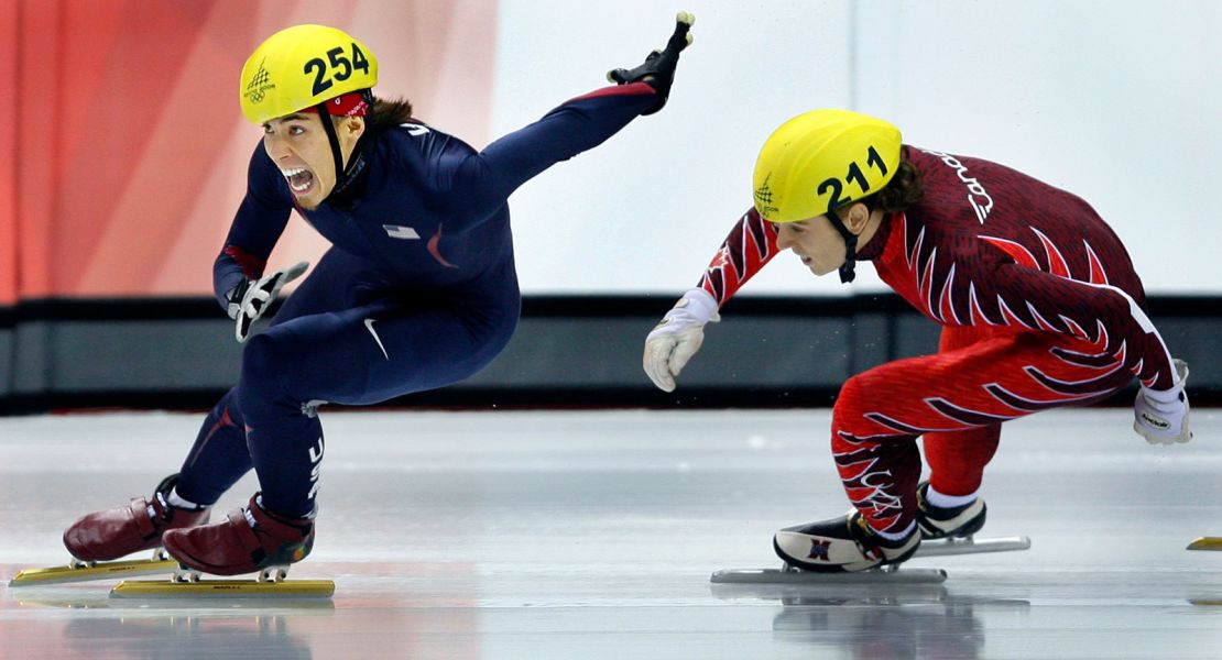 Apolo Ohno, left, of the United States, holds off François-Louis Tremblay, right, of Canada, to win the gold medal in the men's 500-meter finals at the Turin Games.