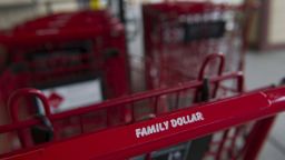Family Dollar Stores Inc. signage is displayed on a shopping cart at a location in Davis, California, U.S., on Tuesday, Aug. 5, 2014.