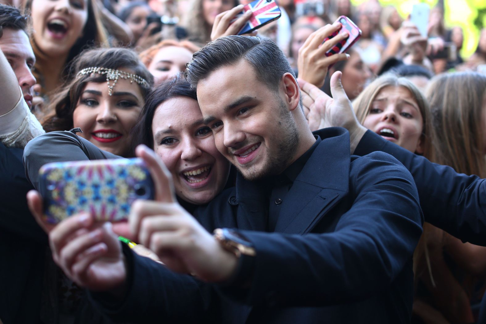 Payne takes a selfie with fans at the 2014 ARIA Awards in Sydney.