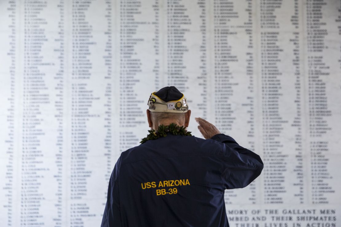 Lou Conter salutes the remembrance wall of the USS Arizona during a memorial service on December 7, 2014, in Pearl Harbor.