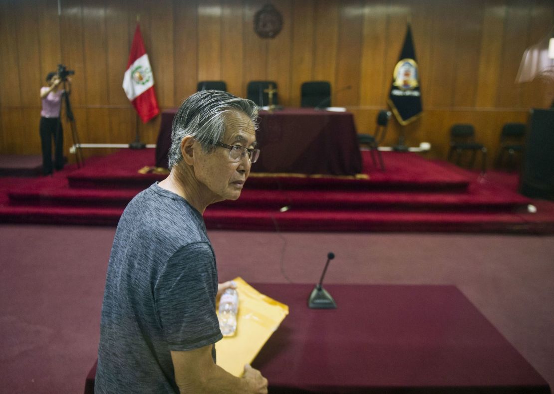 Peru's former President Alberto Fujimori arrives for the reading of a verdict on charges of embezzling state funds and using them to manipulate the media, at a police base in Lima on January 8, 2015.