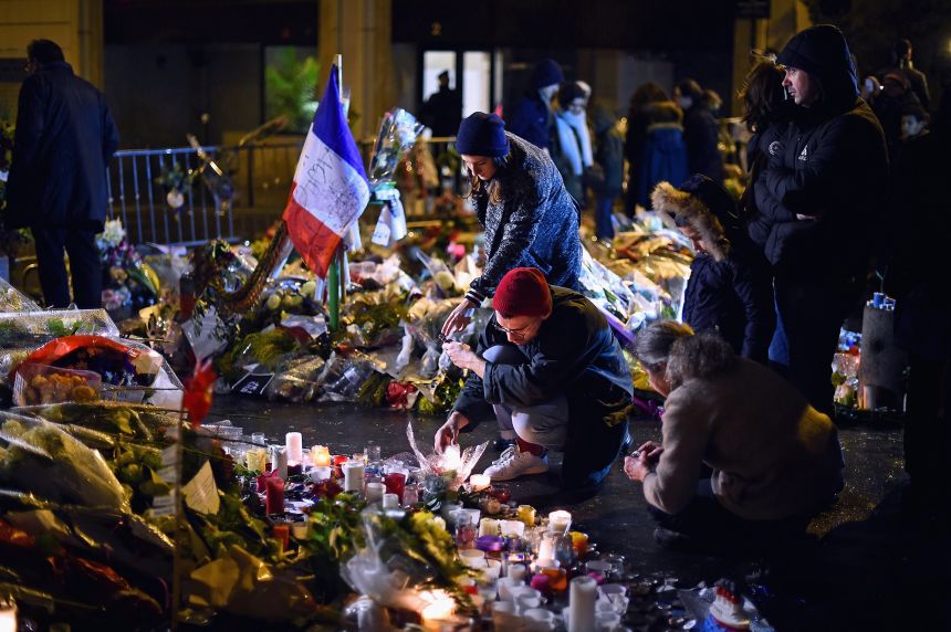 Members of public the light candles in tribute near the offices of French satirical magazine Charlie Hebdo on January 10, 2015 in Paris, France.