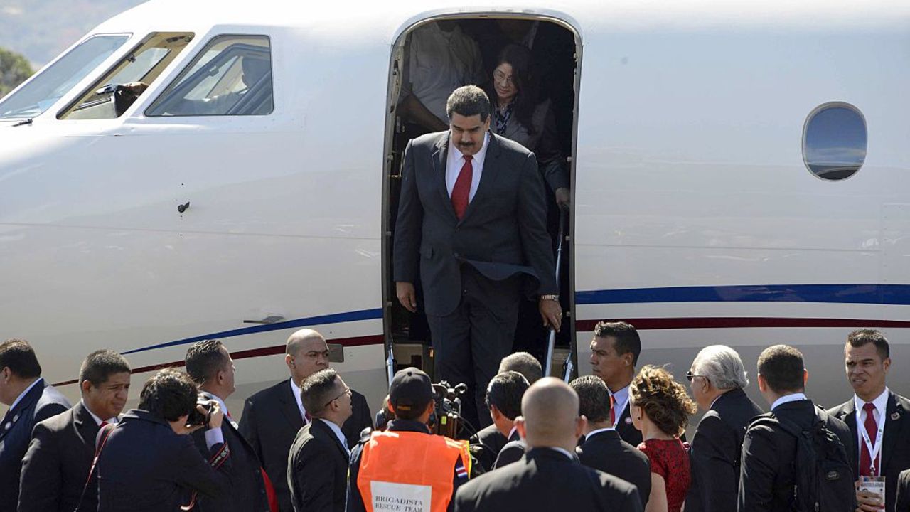 Venezuelan President Nicolas Maduro alights from the plane upon his arrival at the Santa Maria airport, 22 km north of San Jose, on January 28, 2015 to take part in the III CELAC Summit.AFP PHOTO/Ezequiel BECERRA        (Photo credit should read EZEQUIEL BECERRA/AFP via Getty Images)