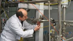 An unidentified International Atomic Energy Agency (IAEA) inspector disconnects the connections between the twin cascades for 20 percent uranium production at nuclear research centre of Natanz, some 300 kilometres south of Tehran on January, 20, 2014 as Iran halted production of 20 percent enriched uranium, marking the coming into force of an interim deal with world powers on its disputed nuclear programme. AFP PHOTO/IRNA/KAZEM GHANE (Photo by KAZEM GHANE / IRNA / AFP) (Photo by KAZEM GHANE/IRNA/AFP via Getty Images)
