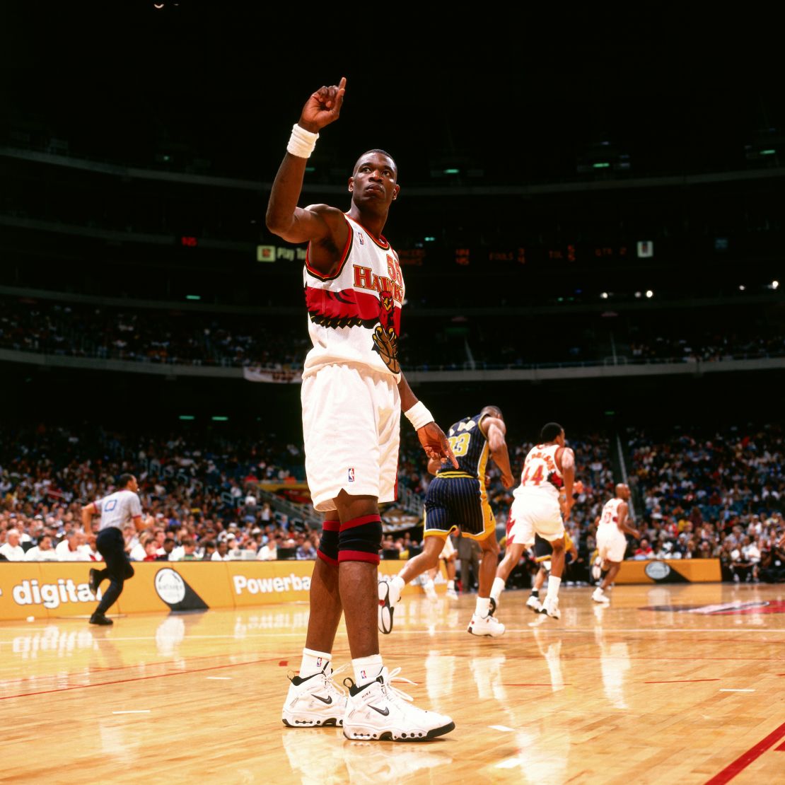 Dikembe Mutombo wags his finger during a game in Atlanta in 1998. He would often use his iconic gesture after blocking an opponent's shot.