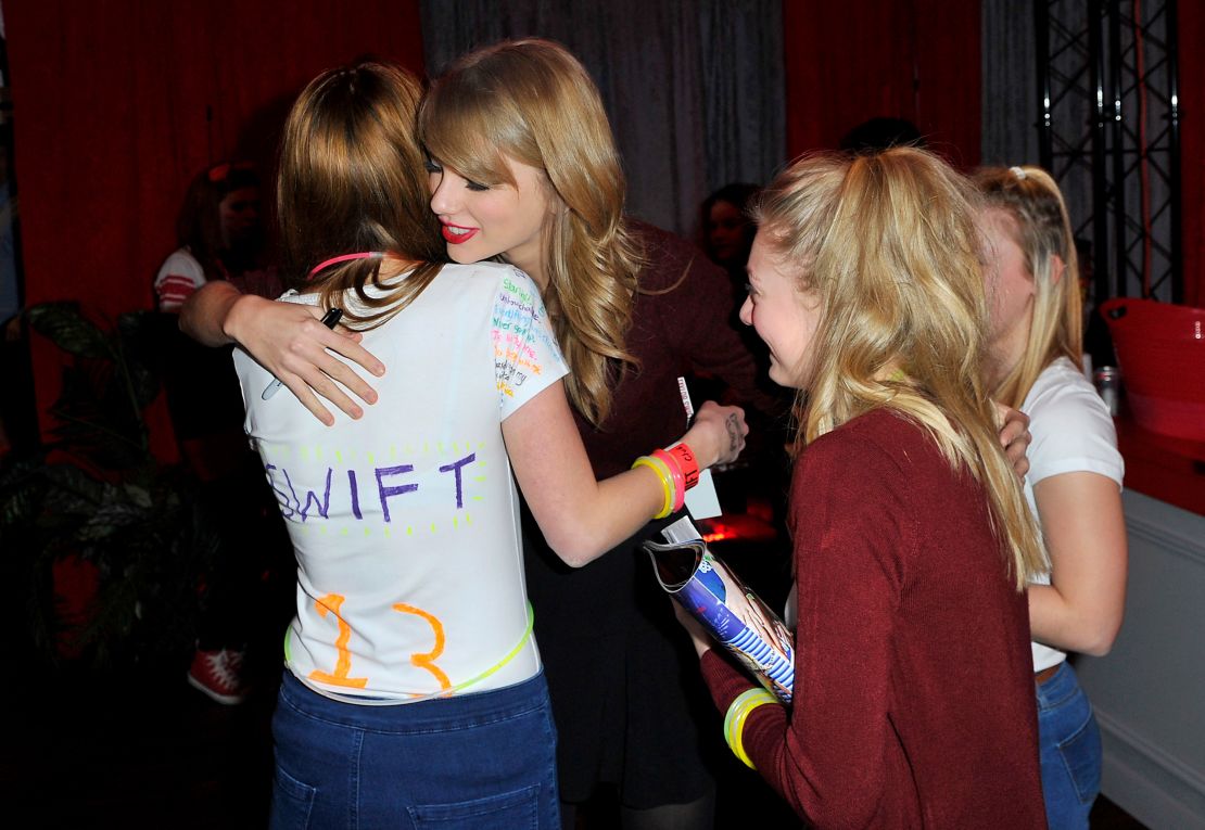 Taylor Swift, pictured with fans at a meet-and-greet on her 2014 tour, no longer interacts with fans as directly as she did a decade ago.