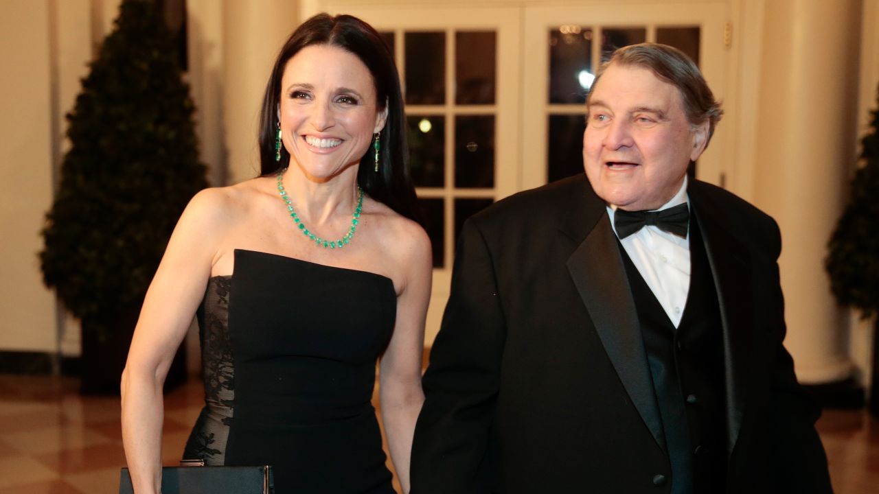 Actress Julia Louis-Dreyfus, left, and her father William Louis-Dreyfus arrive at a state dinner hosted by U.S. President Barack Obama and U.S. First Lady Michelle Obama in honor of French President Francois Hollande at the White House in Washington, D.C., U.S., on Tuesday, Feb. 11, 2014.