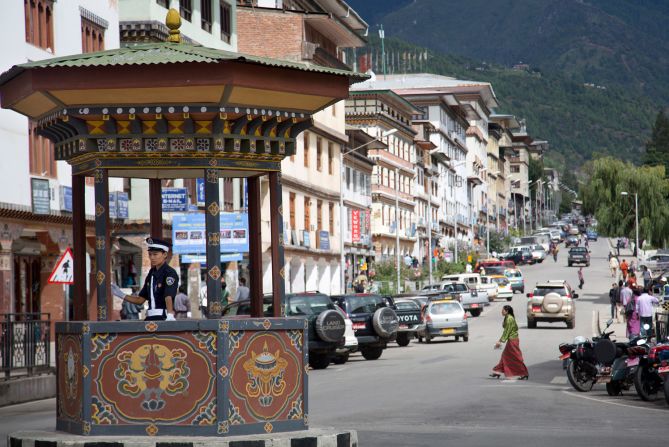 <strong>Rush hour:</strong> Bhutan doesn't have any traffic lights. At the capital Thimpu's busiest roundabout, a police officer (pictured) is assigned to sit in a booth and conduct traffic.