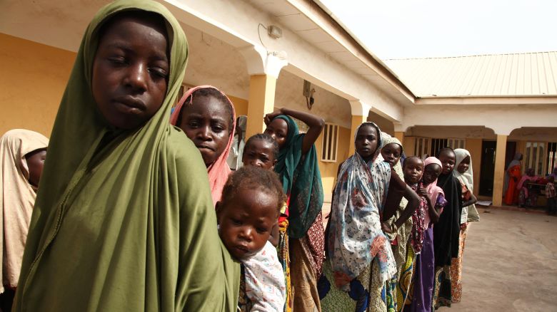 Girls rescued by Nigerian soldiers from Islamist militants Boko Haram at Sambisa Forest line up to collect donated clothes at the Malkohi refugee camp in Yola on May 5, 2015.