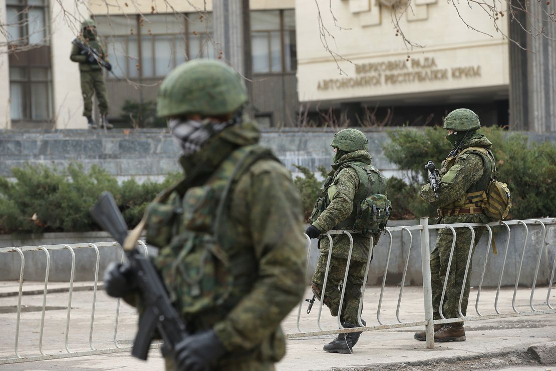 Heavily-armed soldiers without identifying insignia guard the Crimean parliament building shortly after taking up positions there on March 1, 2014 in Simferopol, Ukraine.