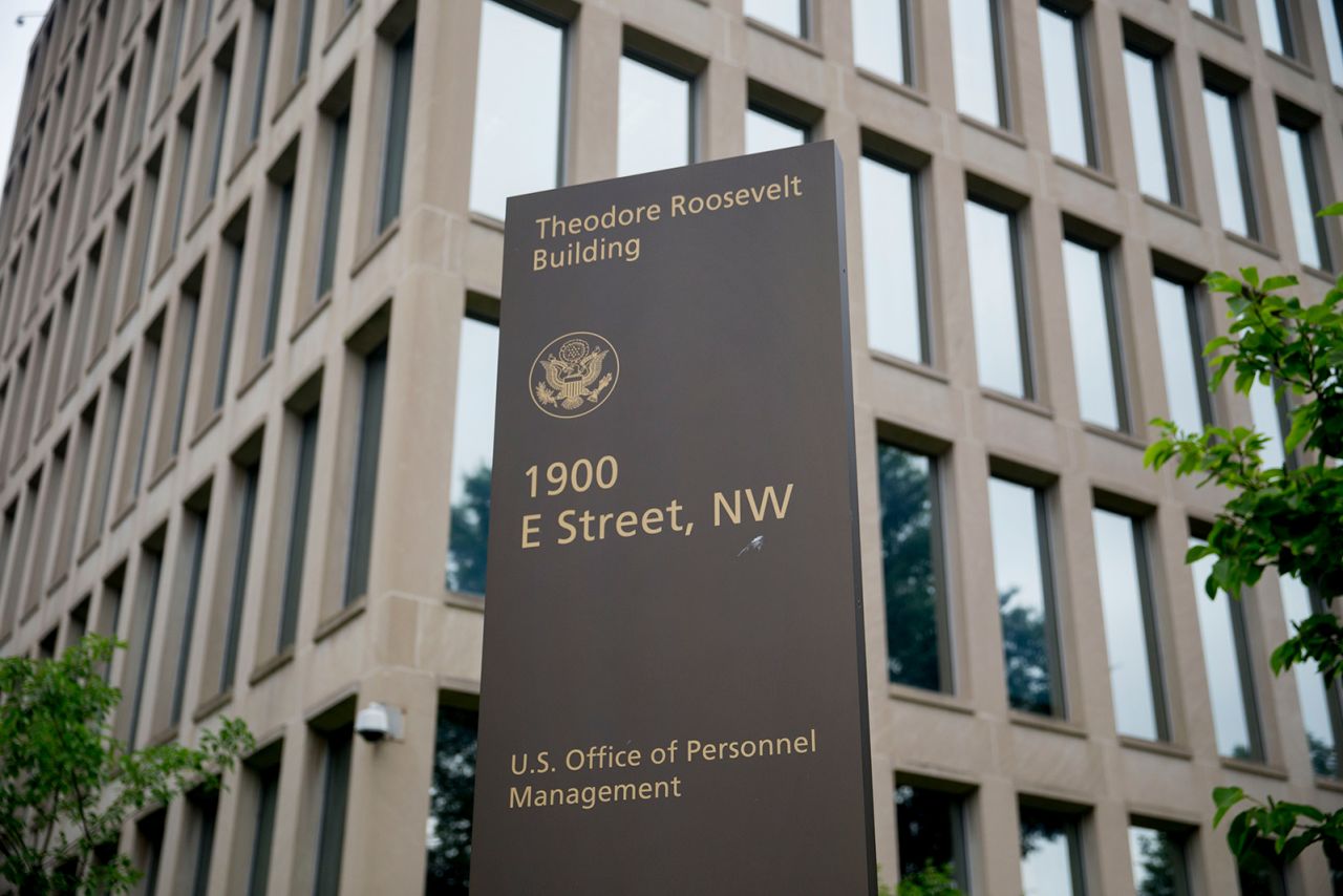 A sign stands outside of the Theodore Roosevelt Building, headquarters of the U.S. Office of Personnel Management (OPM), in Washington, D.C., on June 5, 2015.