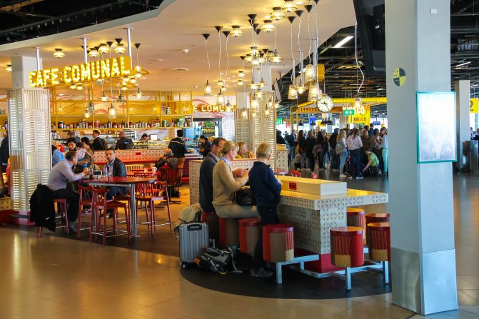Amsterdam Schiphol, Netherlands - April 18, 2015: Passengers relax in the cafe Comunal at the airport Amsterdam Schiphol, Netherlands