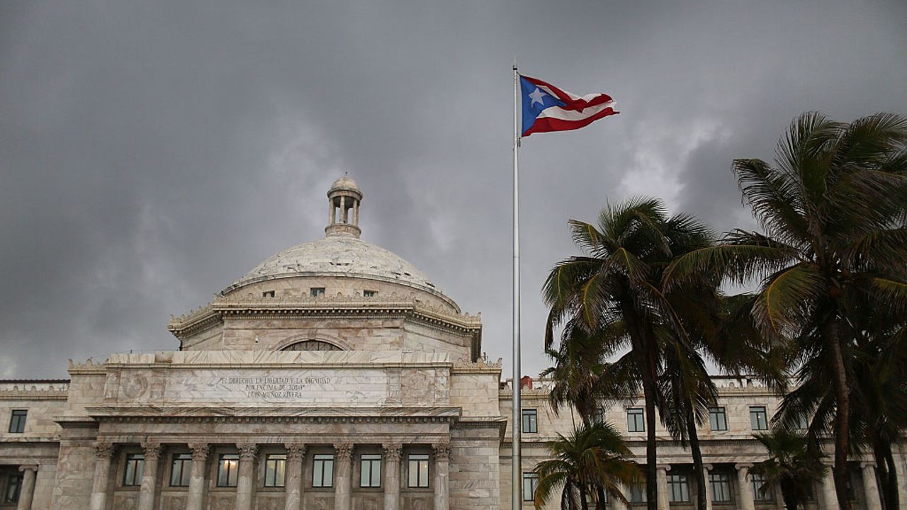 SAN JUAN, PUERTO RICO - JULY 01:  The Puerto Rican flag flies near the Capitol building as the island's residents deal with the government's $72 billion debt on July 1, 2015 in San Juan, Puerto Rico. Governor of Puerto Rico Alejandro García Padilla said in a speech recently that the people of Puerto Rico will have to make sacrifices and share the responsibilities to help pull the island out of debt. (Photo by Joe Raedle/Getty Images)