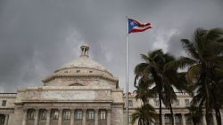 SAN JUAN, PUERTO RICO - JULY 01:  The Puerto Rican flag flies near the Capitol building as the island's residents deal with the government's $72 billion debt on July 1, 2015 in San Juan, Puerto Rico. Governor of Puerto Rico Alejandro García Padilla said in a speech recently that the people of Puerto Rico will have to make sacrifices and share the responsibilities to help pull the island out of debt. (Photo by Joe Raedle/Getty Images)