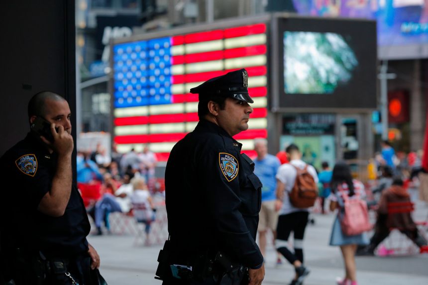 New York Police Department officers stand guard at Times Square in New York on July 4, 2015.