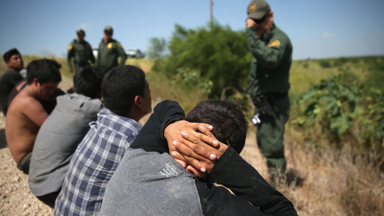 MCALLEN, TX - AUGUST 07: U.S. Border Patrol agents detain undocumented immigrants after they crossed the border from Mexico into the United States on August 7, 2015 in McAllen, Texas. The state's Rio Grande Valley corridor is the busiest illegal border crossing into the United States. Border security and immigration have become major issues in the U.S. presidential campaigns. (Photo by John Moore/Getty Images)