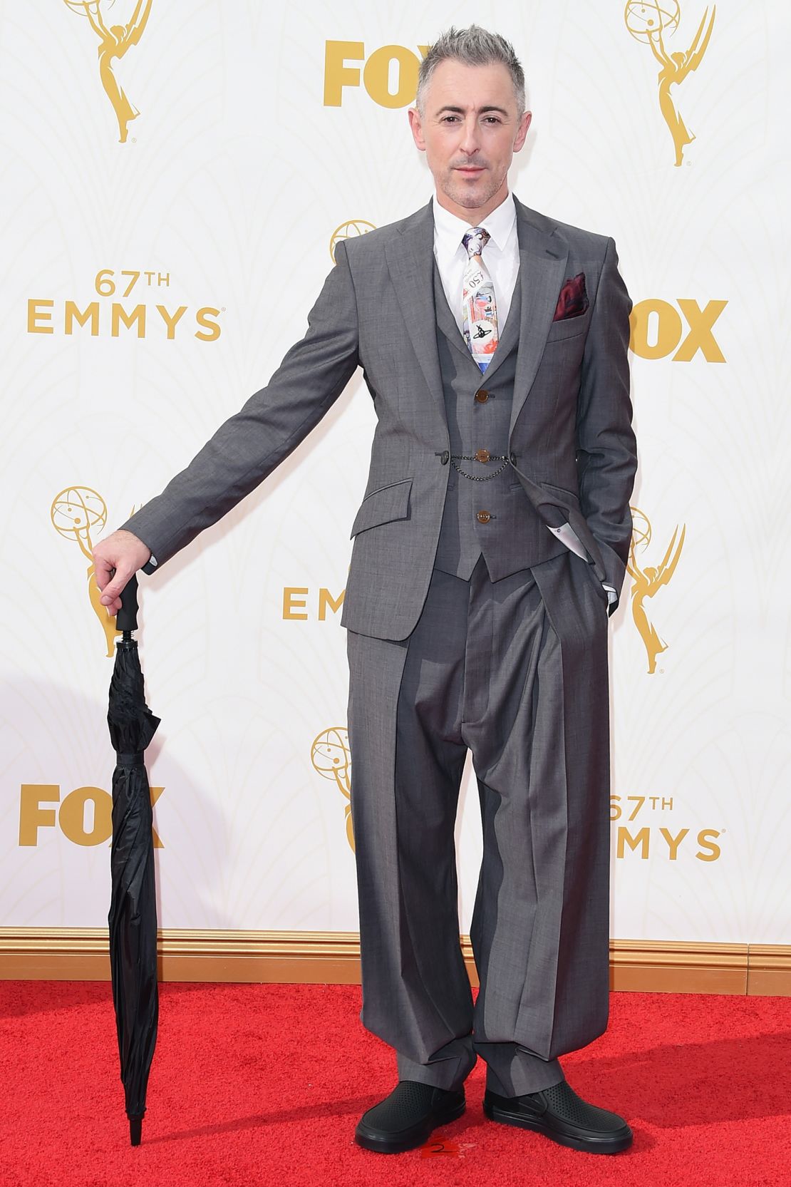 Alan Cumming attends the 67th Primetime Emmy Awards in a Vivienne Westwood suit and black Crocs.