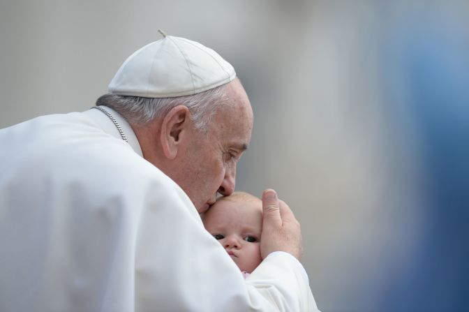 The Pope kisses a baby at the Vatican in October 2015.