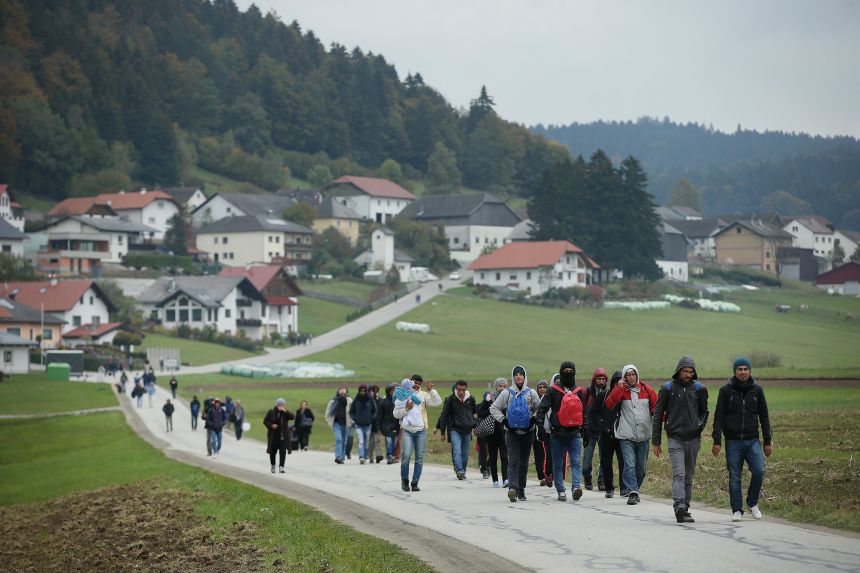Migrants, arriving via buses chartered by Austrian authorities, walk towards Germany on October 17, 2015, near Mistleburg, Austria.