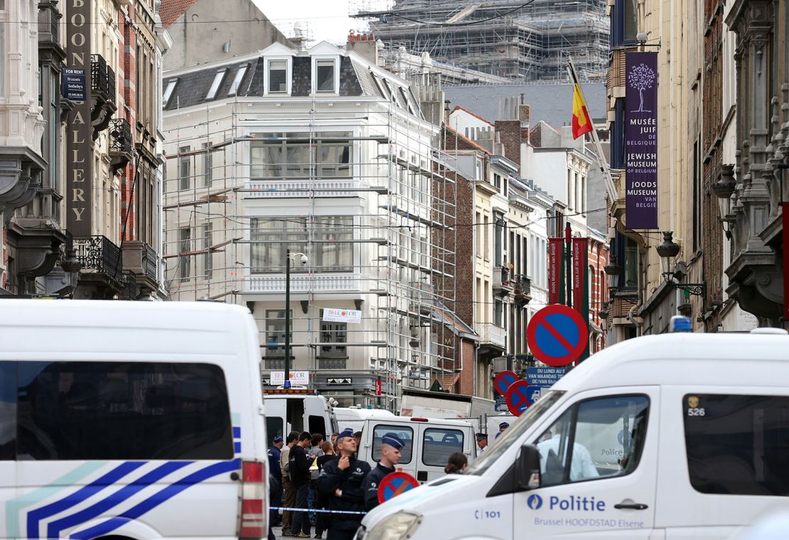 Policemen close the access of the scene of a shooting near the Jewish Museum in Brussels, on May 24, 2014 which left four people dead.