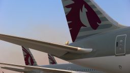 The logo of Qatar Airways Ltd. sits on the tail fins of display aircraft including a Boeing 787-800 Dreamliner, manufactured by Boeing Co., right, an Airbus A350-900, left, and an Airbus A380-800, manufactured by Airbus SAS, on the opening day of the 14th Dubai Air Show at Dubai World Central (DWC) in Dubai, United Arab Emirates, on Sunday, Nov. 8, 2015. The Dubai Air Show is the biggest aerospace event in the Middle East, Asia and Africa and runs Nov. 8 - 12. Photographer: Jasper Juinen/Bloomberg via Getty Images