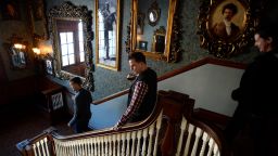 ESTES PARK, CO - JANUARY 12: Visitors from left to right Landen Jones, Joshua Potter, middle, and Elizabeth Myers, right, check out the array of old mirrors and pictures of previous owners  mounted on the walls on the main staircase in the Stanley Hotel on January 12, 2016 in Estes Park, Colorado.  The Stanley Hotel, which first opened in 1909, and known for its architecture, magnificent setting, and famous visitors, may possibly be best known today for its inspirational role in the Stephen King's novel, "The Shining." This Colorado hotel has been featured as one of America's most haunted hotels and with the numerous stories from visitors and staff. (Photo by Helen H. Richardson/The Denver Post via Getty Images)