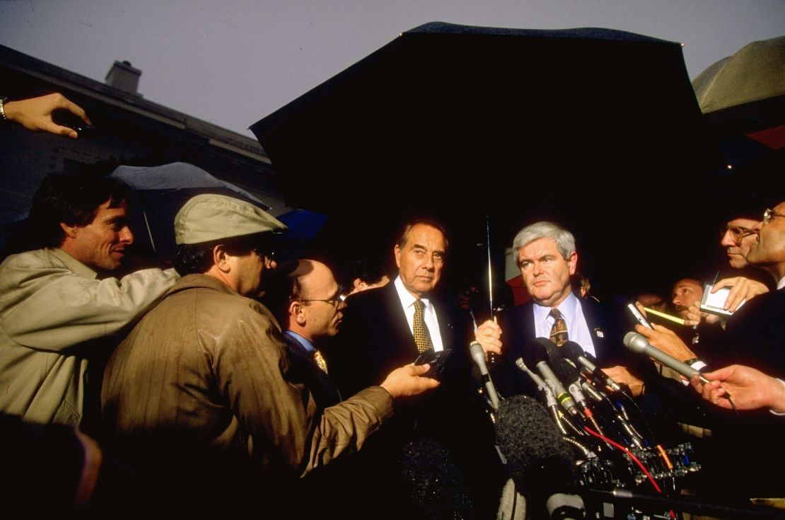 Sen. Bob Dole and House Speaker Newt Gingrich speak to press in the White House driveway after a meeting with President Clinton in November 1995.