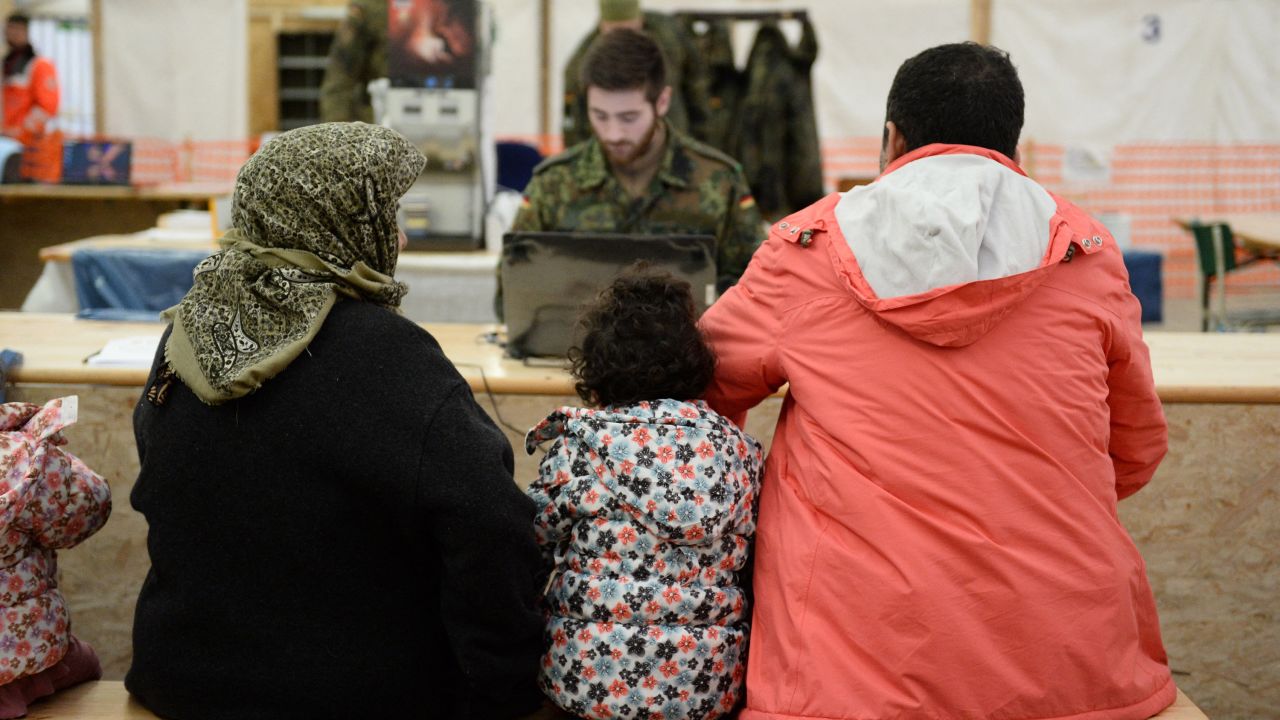 Refugees from Syria wait to register at the German army's air base in Erding, southern Germany, on January 31, 2016. - Germany's eurosceptic right-wing populist AfD party created a storm by suggesting police "if need be" should threaten to shoot migrants seeking to enter the country.
