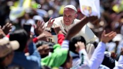 TOPSHOT - Pope Francis waves from the popemobile in San Cristobal de Las Casas on February 15, 2016. Thousands of indigenous Mexicans flocked on Monday to a field in the impoverished southern state of Chiapas to attend Pope Francis' mass in three native languages. AFP PHOTO / RONALDO SCHEMIDT / AFP / RONALDO SCHEMIDT (Photo credit should read RONALDO SCHEMIDT/AFP via Getty Images)