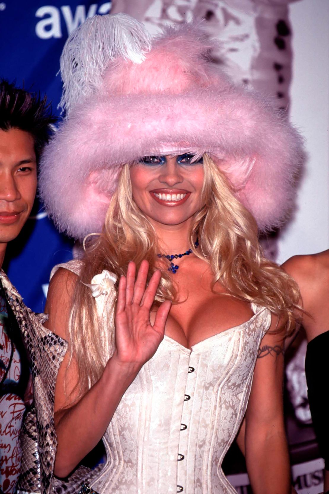 Pam Anderson's feathered pink hat stood out during a night of many looks at the 1999 MTV VMAs.