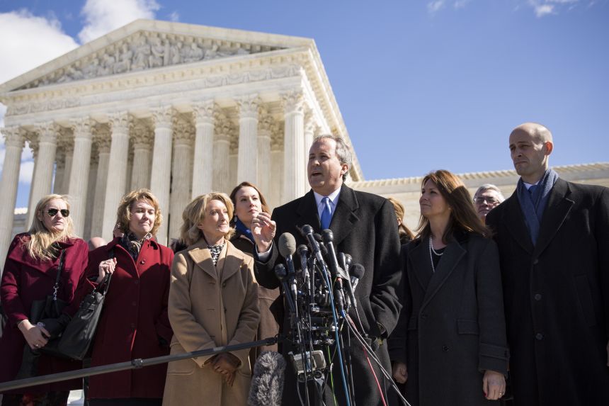 Ken Paxton (3rd R), Attorney General for the state of Texas, and Scott Keller (R), Solicitor General for the state of Texas, speak to the media at the Supreme Court, March 2, 2016 in Washington, DC.