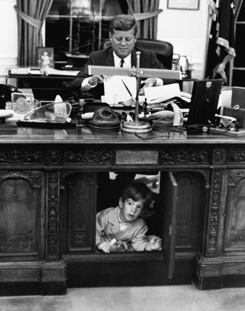 John F. Kennedy Jr. explores his father's desk on May 25, 1962.