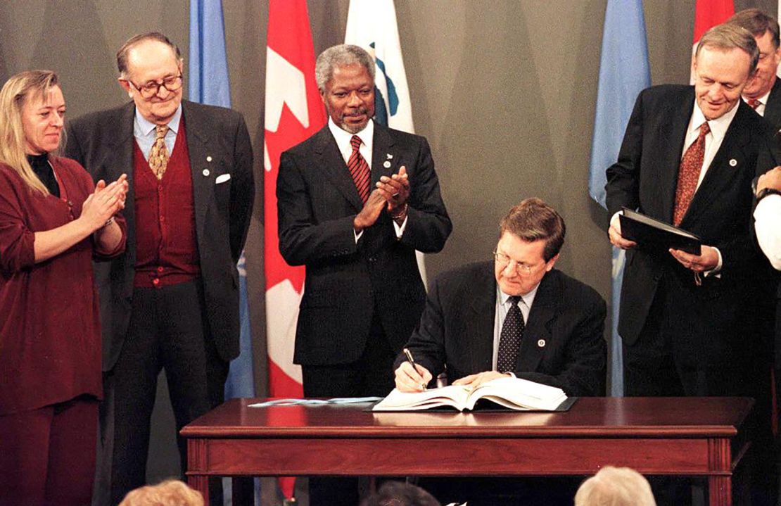 Canada's former foreign minister Lloyd Axworthy signs the treaty to ban the use of anti-personnel landmines.