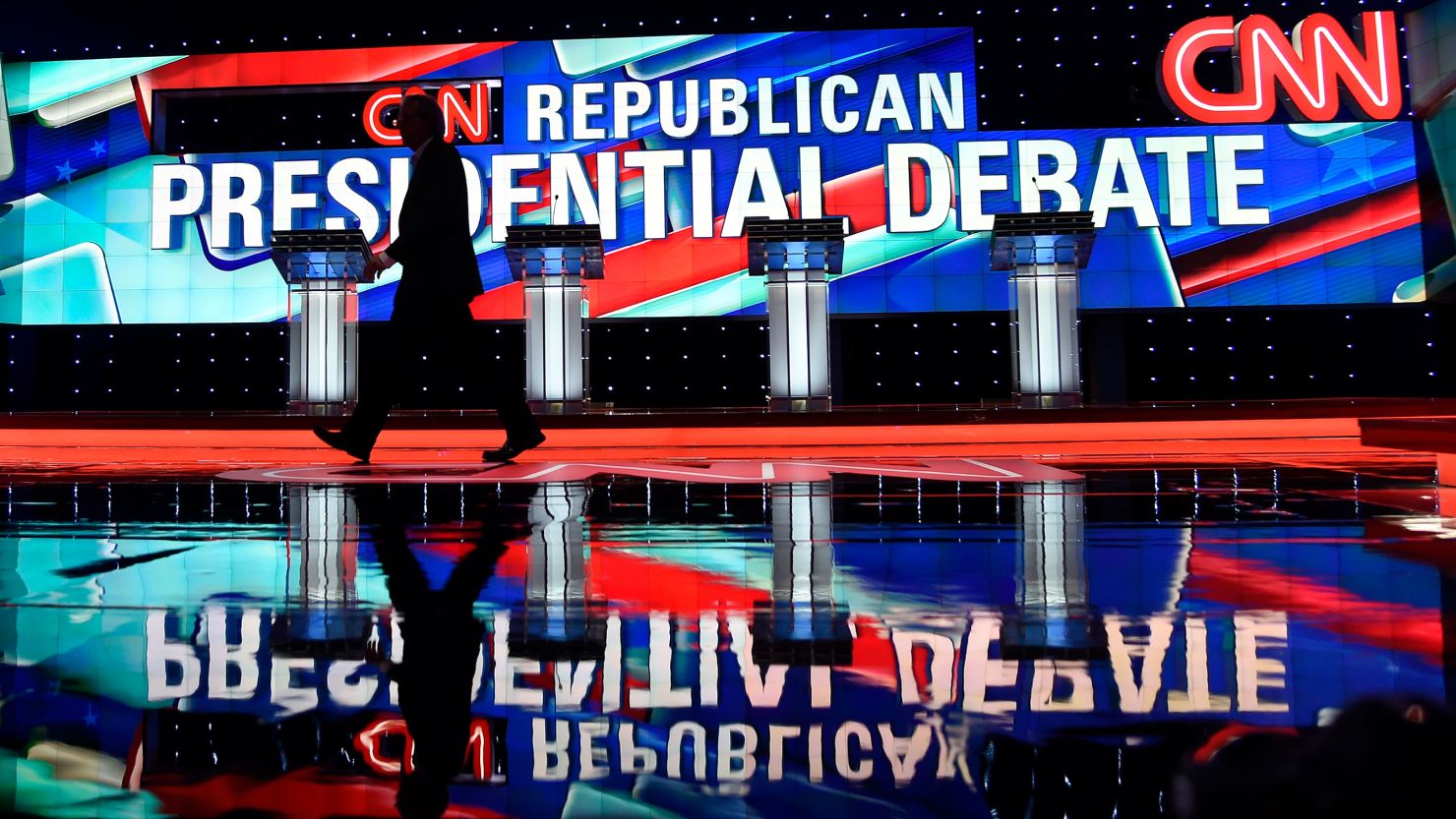 In this March 2016 photo, a worker walks across the stage as CNN prepares for the Republican Presidential Debate in Miami.