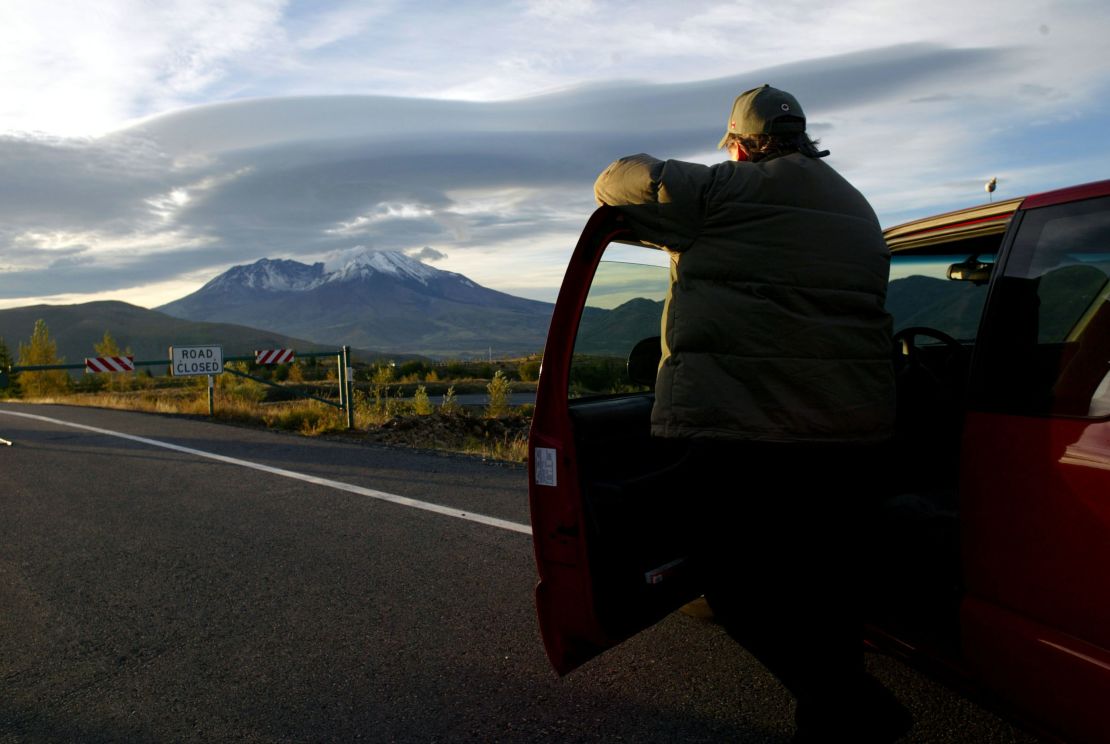 John Quinn of Bothel, Washington, watches as steam erupts from Mount St. Helens on October 12, 2004, at Mount St. Helens National Volcanic Monument, Washington.