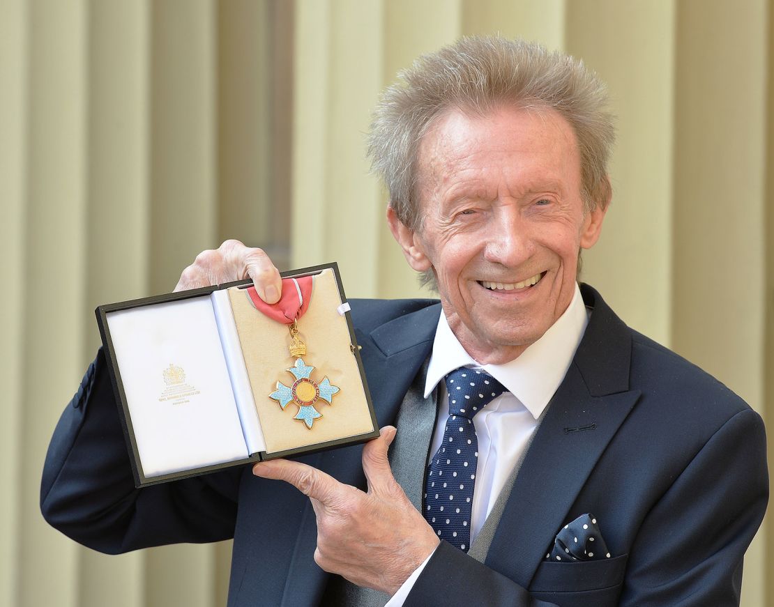 Former Scotland and Manchester United footballer Denis Law poses with his Commander of the Order of the British Empire (CBE) medal.