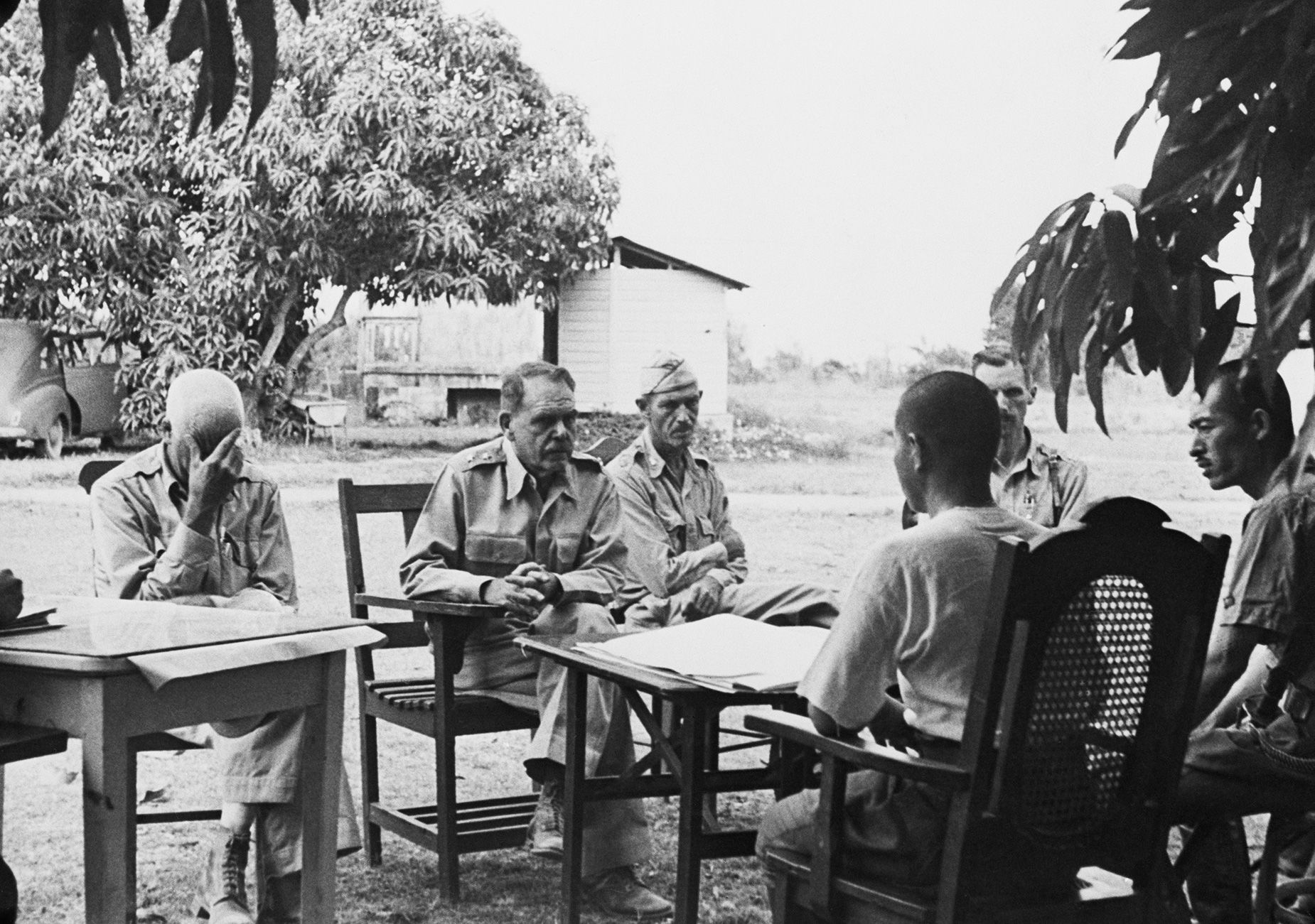 Maj. Gen. Edward P. King (second from left) discusses preliminary terms of surrender on Bataan with Japanese officers following battles along Bataan and Corregidor. Bettmann Archive/Getty Images