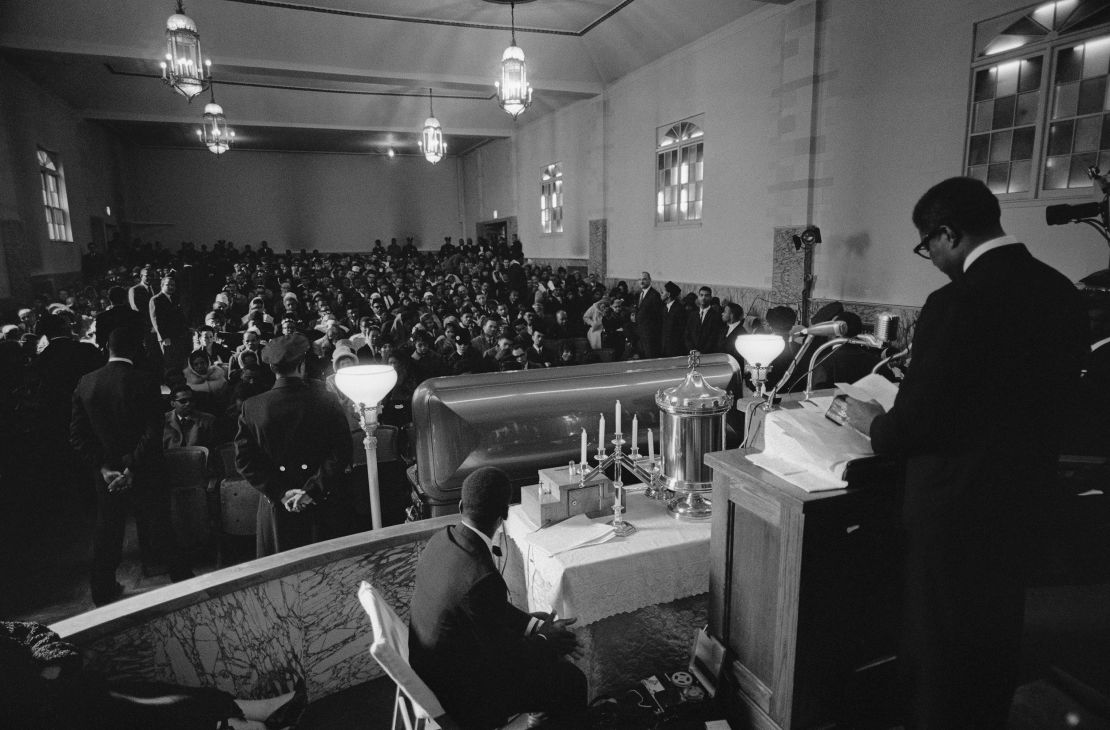 Actor-playwright Ossie Davis speaks to a crowd of some 1,000 people attending Malcolm X's funeral service on February 27, 1965, at the Church of God in Christ in New York City.