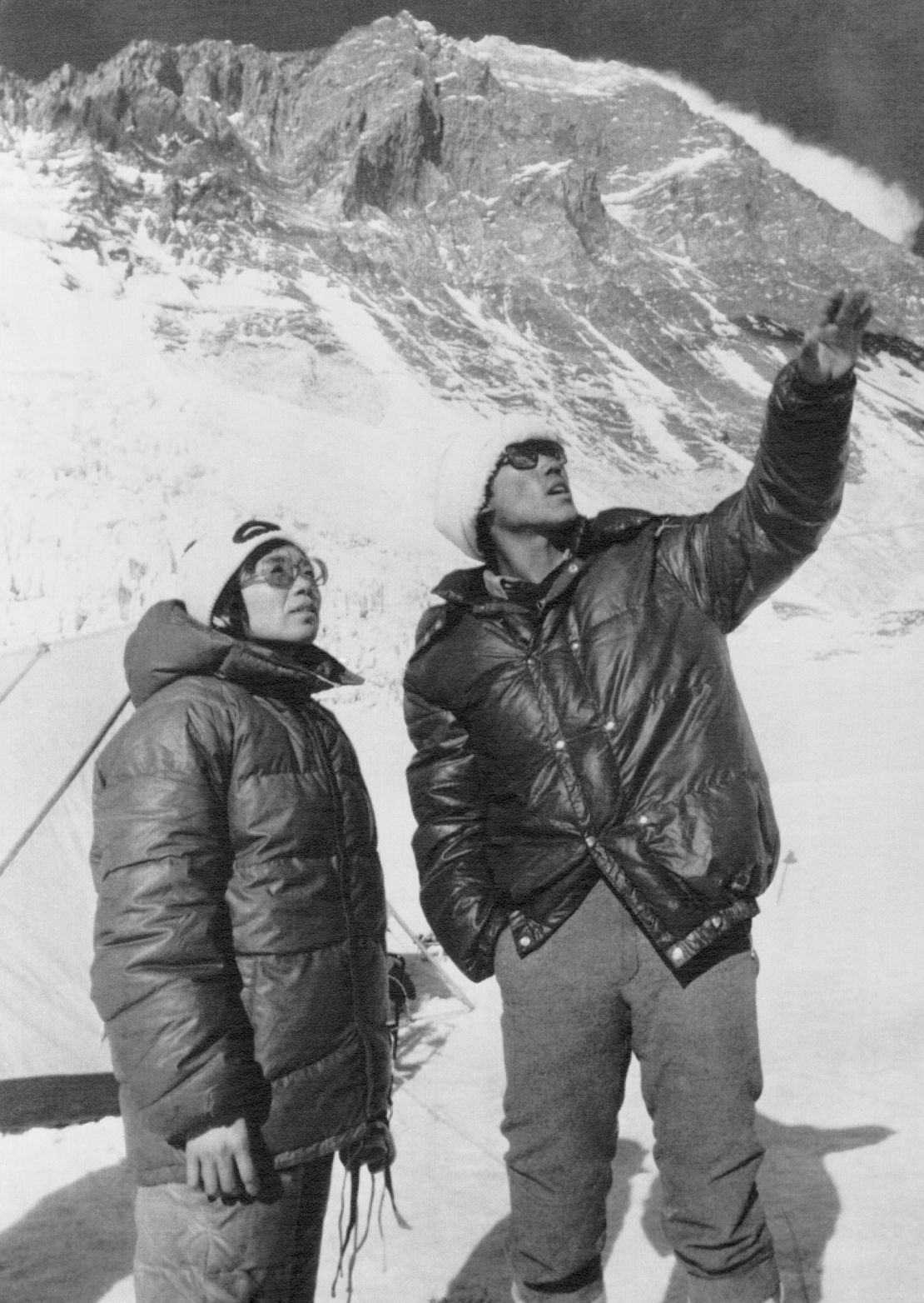 Junko Tabei and Ang Tsering stand near Mount Everest camp two, with the mountain's southern wall behind them. They would reach the summit some two weeks later.
