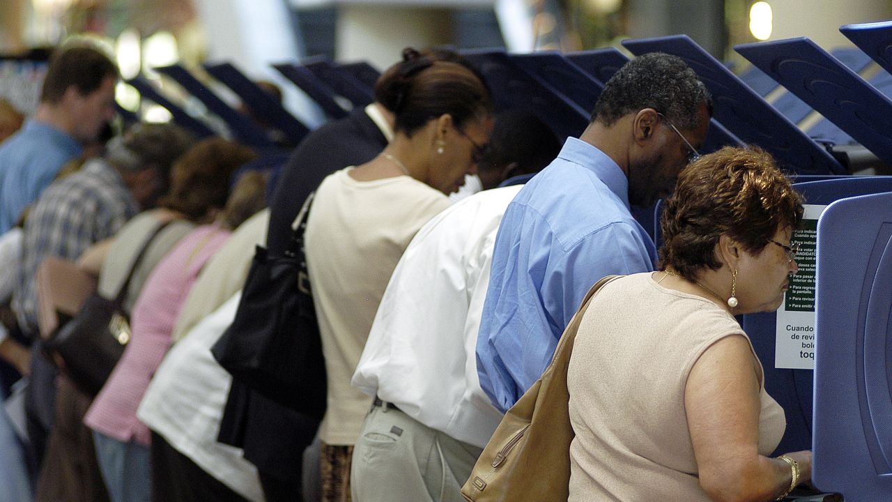 MIAMI - OCTOBER 21:  Hispanic voters go to the polls for early voting at the Miami-Dade Government Center on October 21, 2004 in Miami, Florida. Early voting began this week in Florida and is under heavy scrutiny after the debacle in the 2000 election.  (Photo by G. De Cardenas/Getty Images)