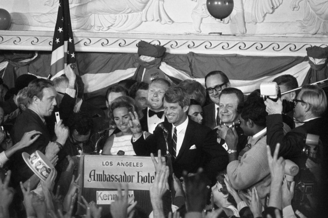 Sen. Robert F. Kennedy gives a victory sign to a huge crowd at the Ambassador Hotel on June 5, 1968, shortly before being fatally shot while exiting the ballroom through the hotel's kitchen.